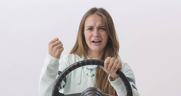 istock Young woman gesturing while driving her car 2233804293
