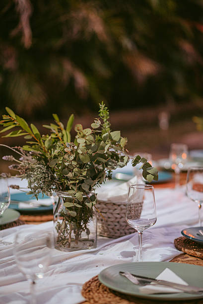 istock Elegant outdoor dining setup with greenery and decorative tableware in a serene setting 2233804604