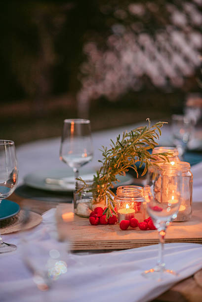 istock Elegant outdoor dinner setting with candles and fresh decorations in a warm evening atmosphere 2233804692