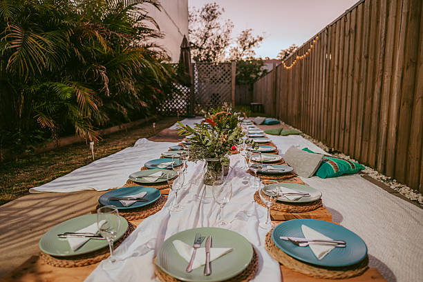 istock Elegant outdoor dining setup featuring a long table with floral centrepiece at sunset 2233804827
