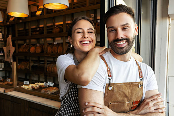 istock Proud young bakery team posing in bread store 2233809007