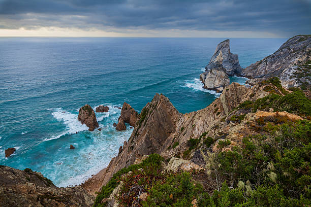 istock A dramatic coastal landscape featuring rugged cliffs, turquoise waters, and crashing waves 2233809826