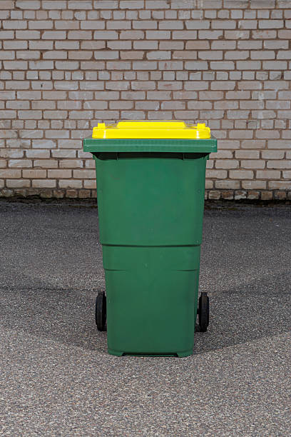 istock Green Outdoor Recycling Bin with Yellow Lid 2233809851