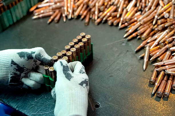 Assembling finished cartridges into transport cases, firearms production.