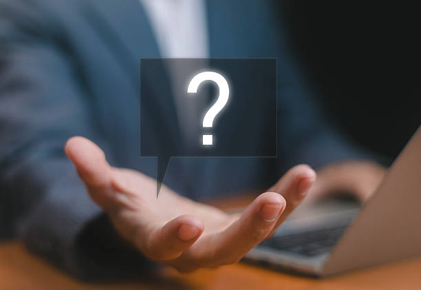 istock Businessman hand with glowing question mark speech bubble, symbolizing uncertainty, decision making, problem solving, customer support, business strategy, and communication in digital workplace. 2233811446