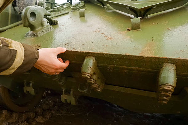 istock Man touches T-72 tank with his hand 2233811838