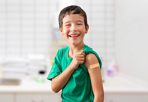 istock Happy child with plaster at the doctor's office 2233814254