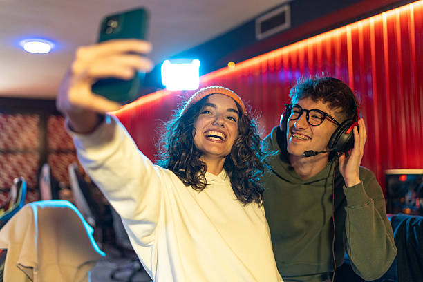 istock Young adults enjoying gaming and selfie moment 2233818430