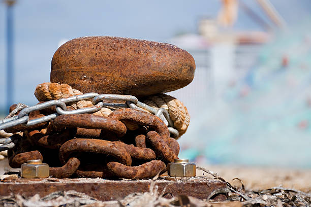 Rusty bollard with chain and rope at the port of Saint-Cyr-sur-Mer, La Madrage