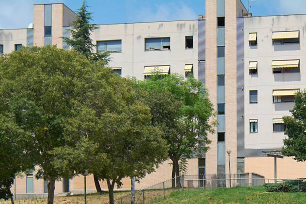 istock Modern apartment building with trees and green spaces. 2233821329