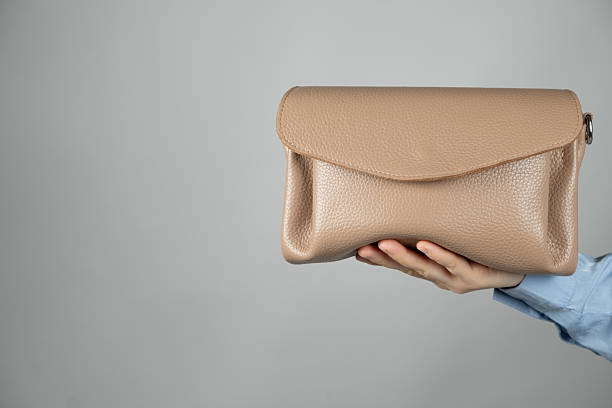 istock Small leather women's handbag in hand, space for text. 2233821391