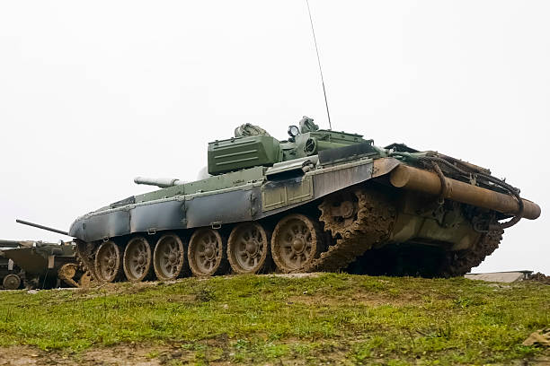 Kubinka, Moscow region, Russia - February 23, 2013: Russian tank on battlefield. Soviet tank attacking Nazi infantry. Soviet tank is T-34-85. Reconstruction of the Second World War battle with the participation of tanks, armored vehicles and infantry. The battle is going on in Military-historical museum of  armored vehicles and armament of Main auto-tank directorate of Defense ministry of Russian Federation known  as \