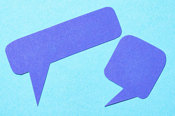 Blank cut out paper speech bubbles with copy space for text on blue background, flat lay top view conceptual conversation backdrop