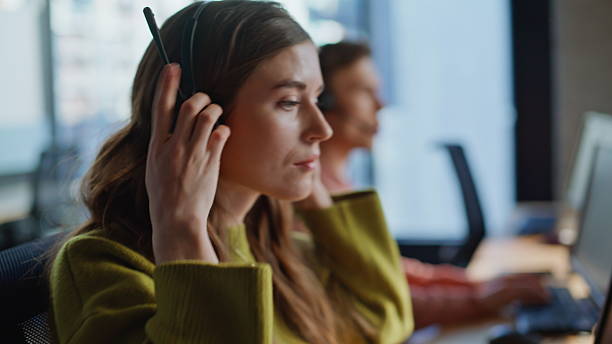 istock Closeup hand grabbing headset communication at workplace. Specialist assisting 2233823082
