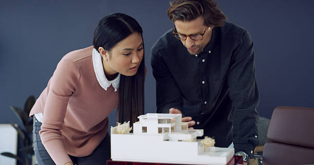 istock Team, architecture and people planning with 3d model, house design or building. Meeting, architect and discussion with prototype, creative engineering or review development for construction in office 2233825458