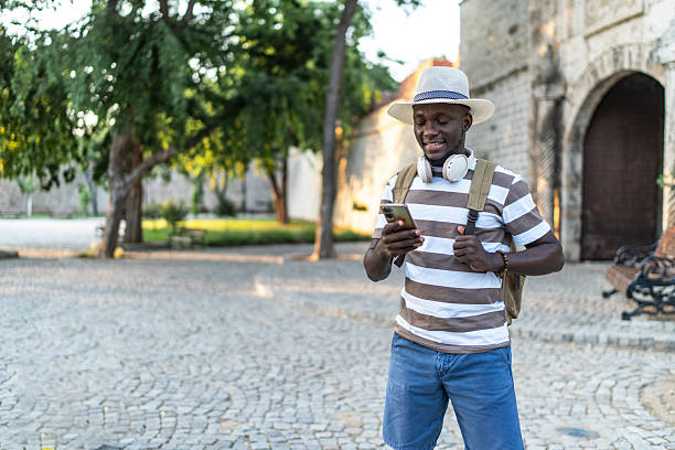 istock Young tourist using smartphone and enjoying summer vacations in an old town 2233826178