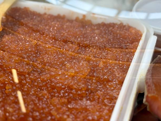 istock Vibrant and Exceptional Salmon Roe Beautifully Presented in a Container for Culinary Delight. Freshly prepared salmon roe is displayed in a container, showcasing its vibrant color and smooth texture 2233827360