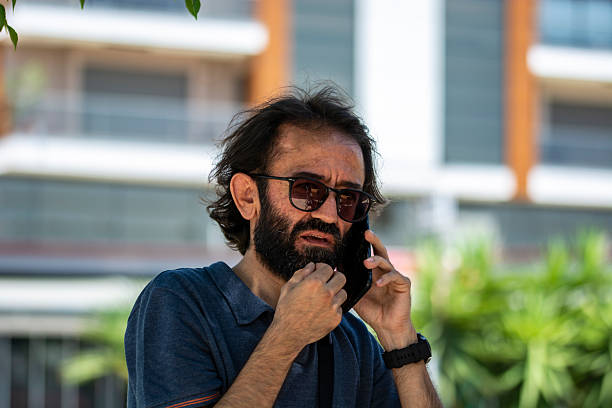 A Man Talking On A Mobile Phone In An Open Area
