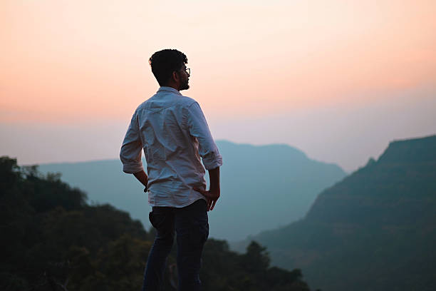 istock Man Admiring Scenic Mountain Sunset 2233829532