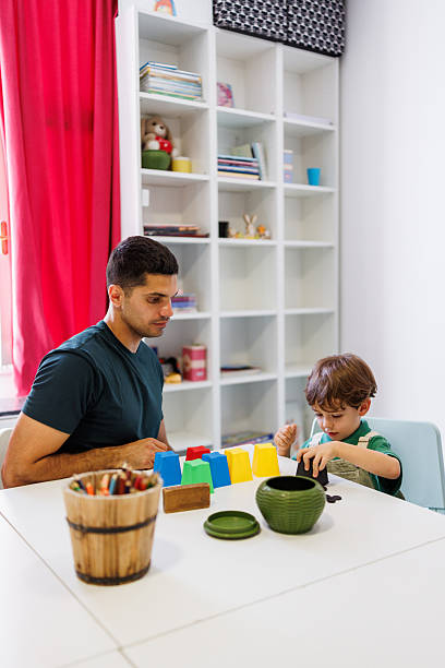 istock Babysitter guiding child’s curiosity with educational toys 2233829855