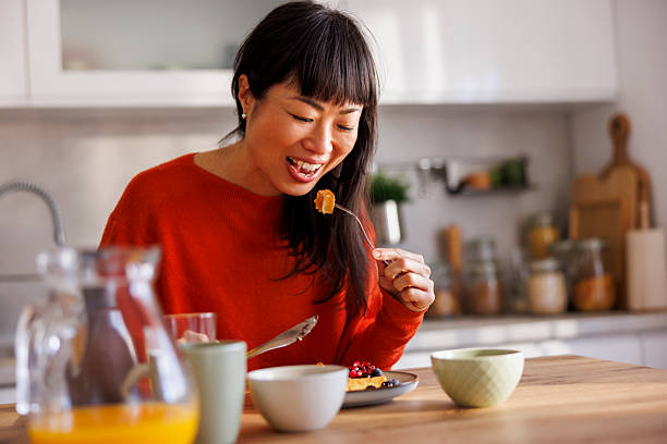 istock Woman having waffles for breakfast at home 2233832043