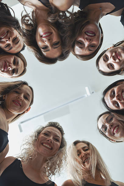 istock Happy Diverse Women Smiling At Camera From Below While Creating Perfect Circle 2233838105