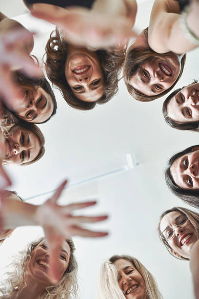 istock Cheerful Women Smiling At Camera From Below 2233838288
