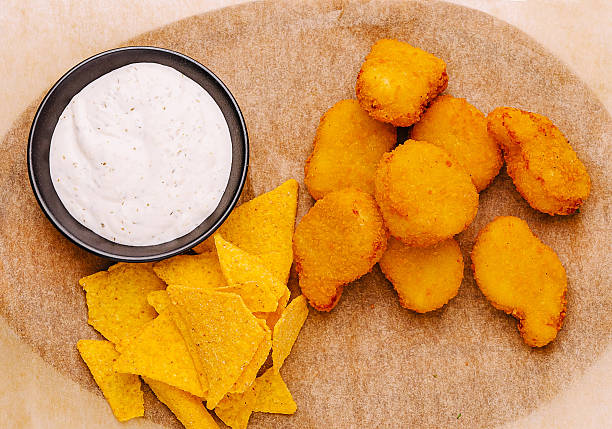 istock Delicious crispy chicken nuggets served with tortilla chips and dip 2233839546