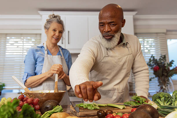 istock Mature Couple Reading Recipe from Invisible Screen – Kitchen Scene 2233840200