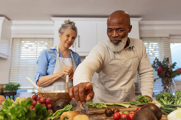 istock Mature Couple Reading Recipe from Invisible Screen – Kitchen Scene 2233840210
