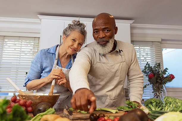 istock Mature Couple Reading Recipe from Invisible Screen – Kitchen Scene 2233840287