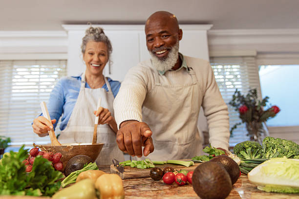 istock Mature Couple Reading Recipe from Invisible Screen – Kitchen Scene 2233840330