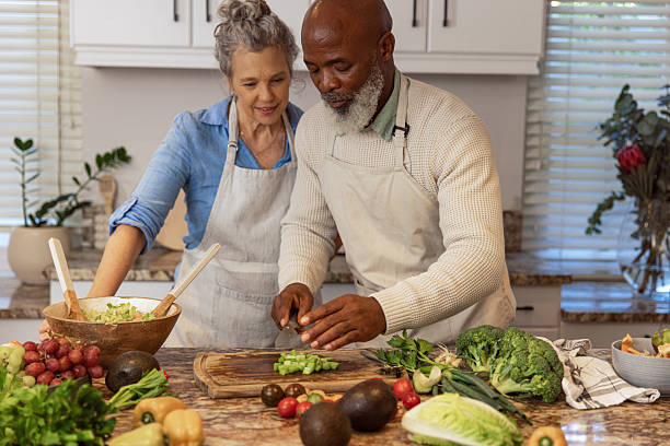 istock Mature Couple Making Healthy Salad Together in Kitchen 2233840433