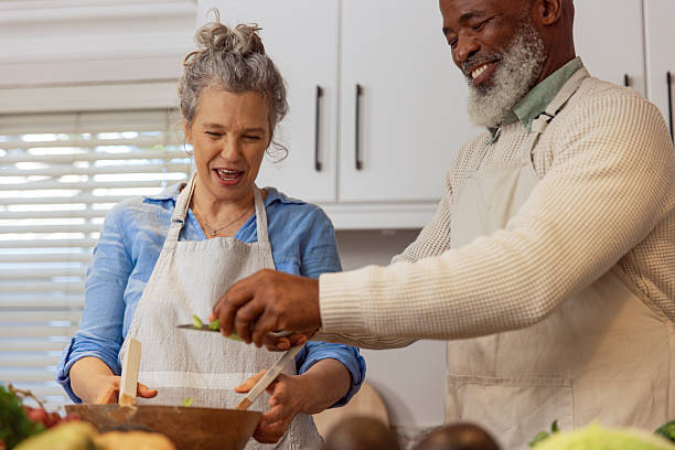 istock Mature Couple Making Healthy Salad Together in Kitchen 2233840471