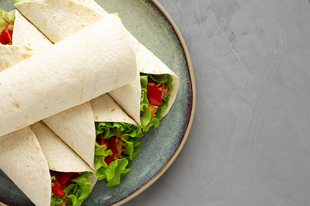 istock Homemade Avocado Tuna Wraps on a Plate, top view. Flat lay, overhead, from above. Copy space. 2233844149