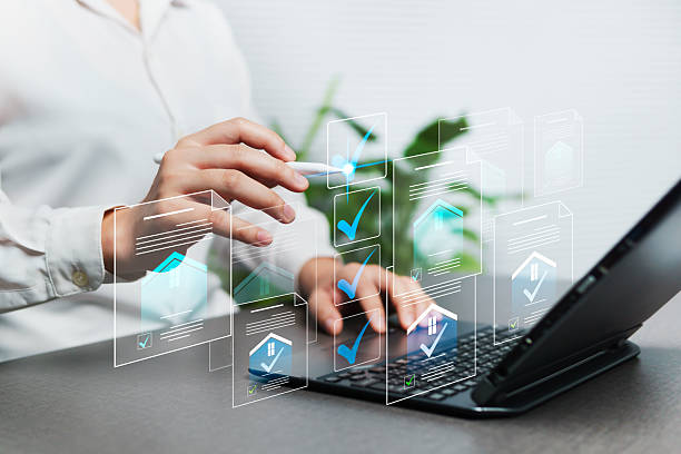 istock Electronic approval and online document management on a virtual screen with a laptop. Business submits an inspection of a residential and real estate project with a secure and paperless data file. 2233845057