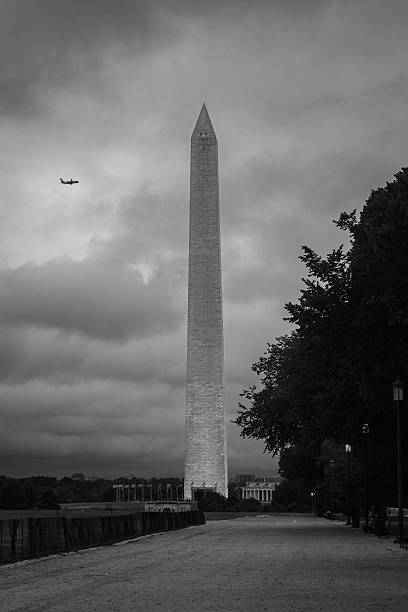 istock Airplane Flies Over the Washington Monument in Black and White 2233845186