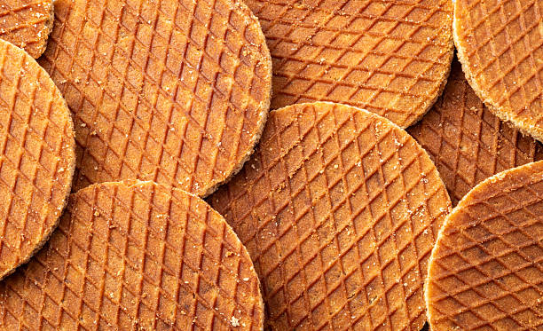 Traditional dutch Stroopwafels spread on the table, texture of round waffle cookie, Full frame.