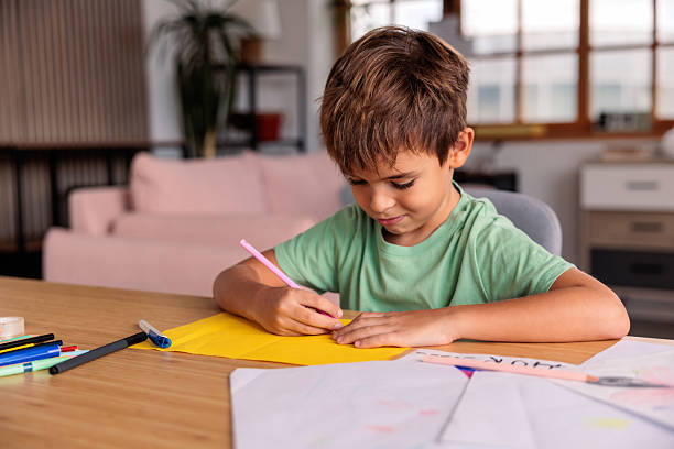 istock Smiling Boy Drawing at Home 2233846159