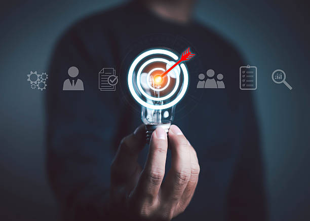 istock Businessman hand holding light bulb with target and arrow icon, symbolizing innovation, digital marketing strategy, goal achievement, and business success in modern technology concept. 2233849182