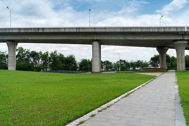 istock Concrete structure and asphalt road space under the overpass in the city 2233849530