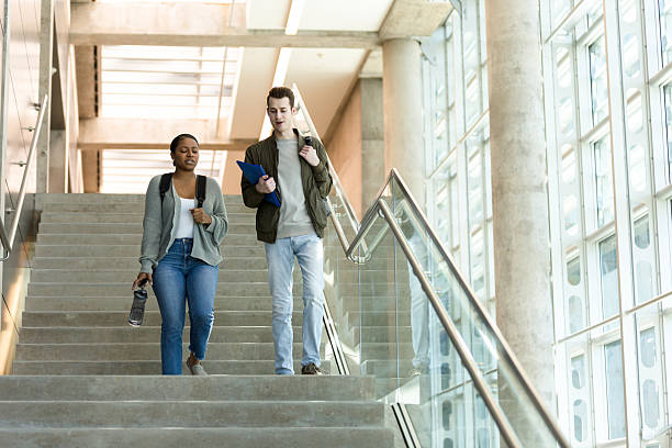 istock Two Diverse Students Walking Upstairs, Casual Campus Life 2233849855