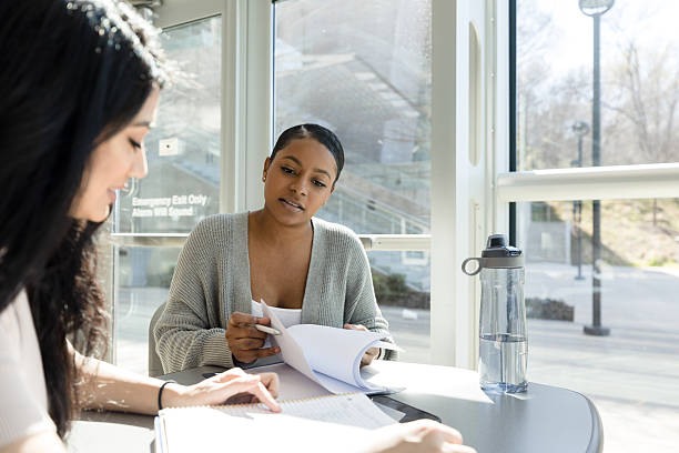 istock Two Diverse Female Students Studying Together in a Classroom 2233849908