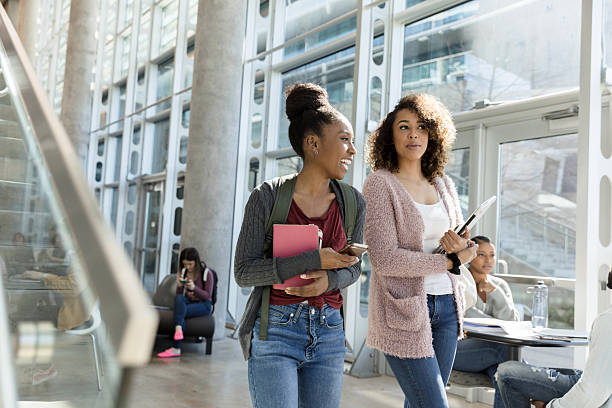 istock Two Smiling Female University Students Walking and Talking 2233849956