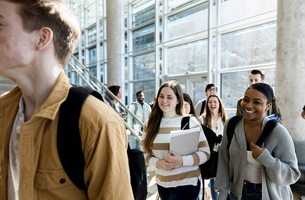 istock Happy Diverse Students Walking in University Building 2233849981