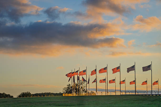 istock American Flags Waving at the Washington Monument at Sunset 2233852659