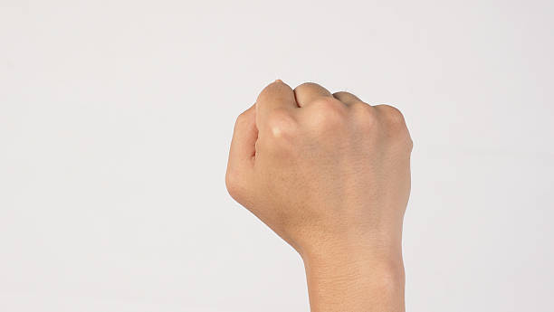 istock a hand forming a closed fist on white background. 2233853169