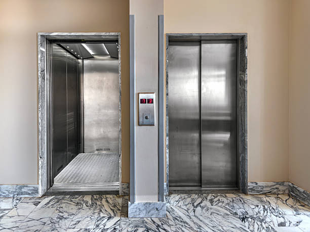 istock Two stretcher elevators, one lift enclosed with stainless steel doors and the other open 2233854423