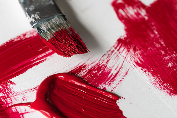A bold red paint smear with a rough, textured surface on a white background. The expressive brushstroke and vibrant color create a dynamic and artistic composition, symbolizing creativity, passion, and raw energy.