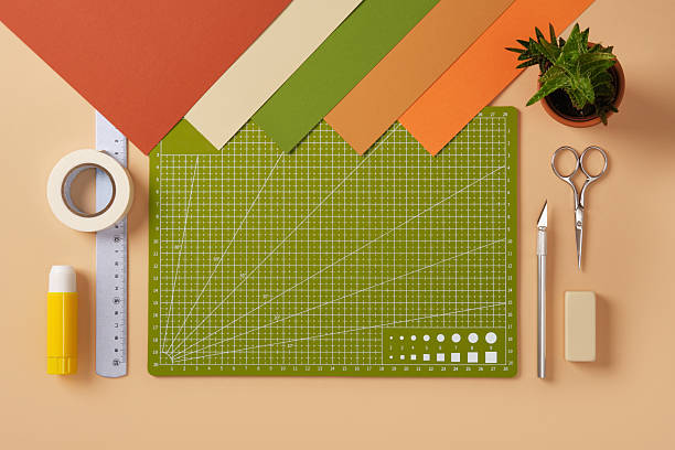 istock Neat desk for paper art. Colored sheets, cutting mat, scissors, knife, eraser. Place for text. 2233854882